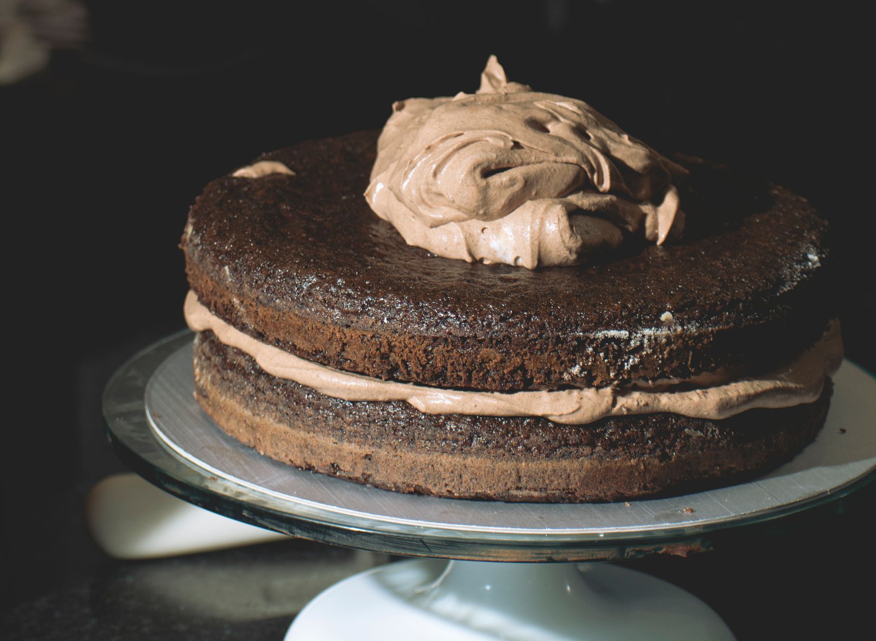 A chocolate layer cake with rich frosting, freshly baked